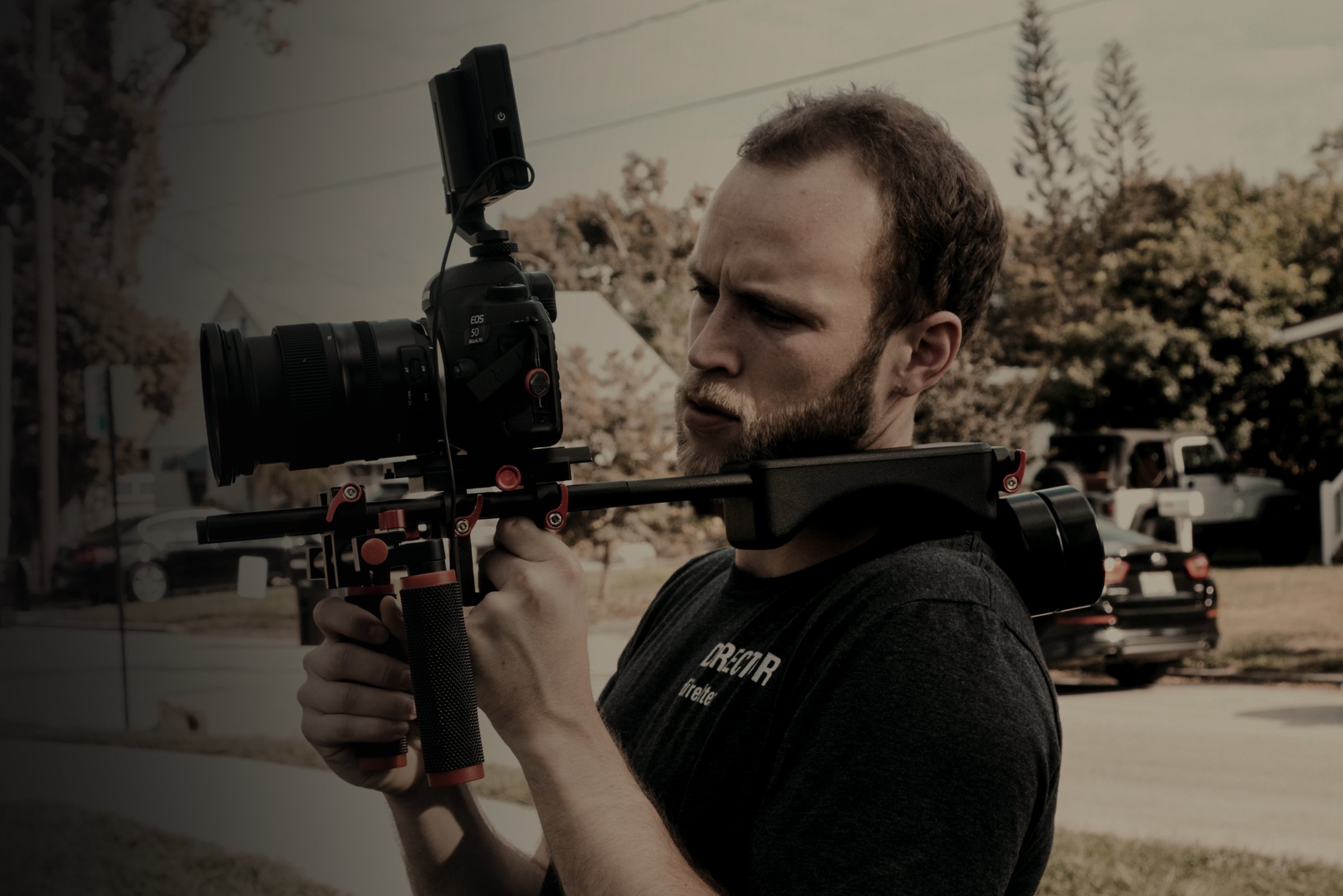 Videographer operating a professional camera rig on location